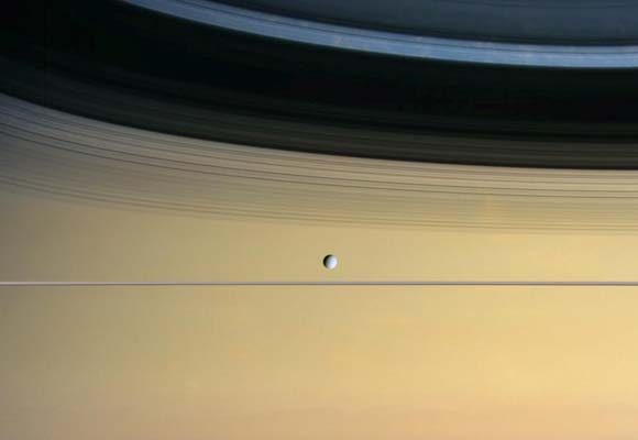 Saturn's Moon Dione in front of Saturn